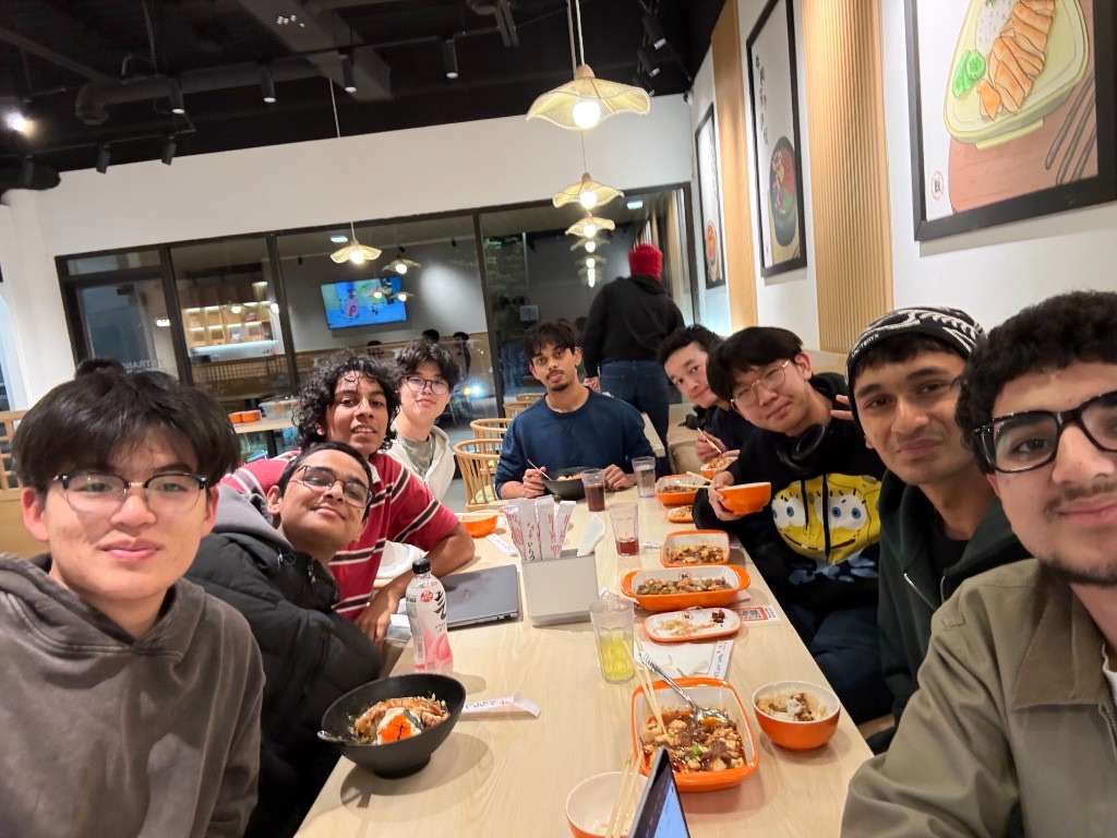 A group of friends sharing a meal around a restaurant table