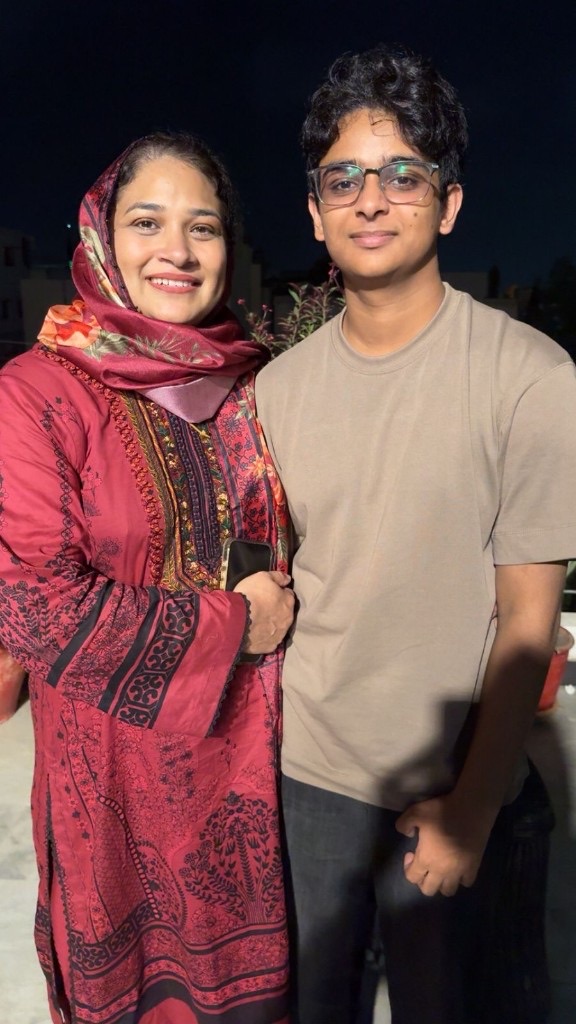 Ali standing beside a family member on a night out