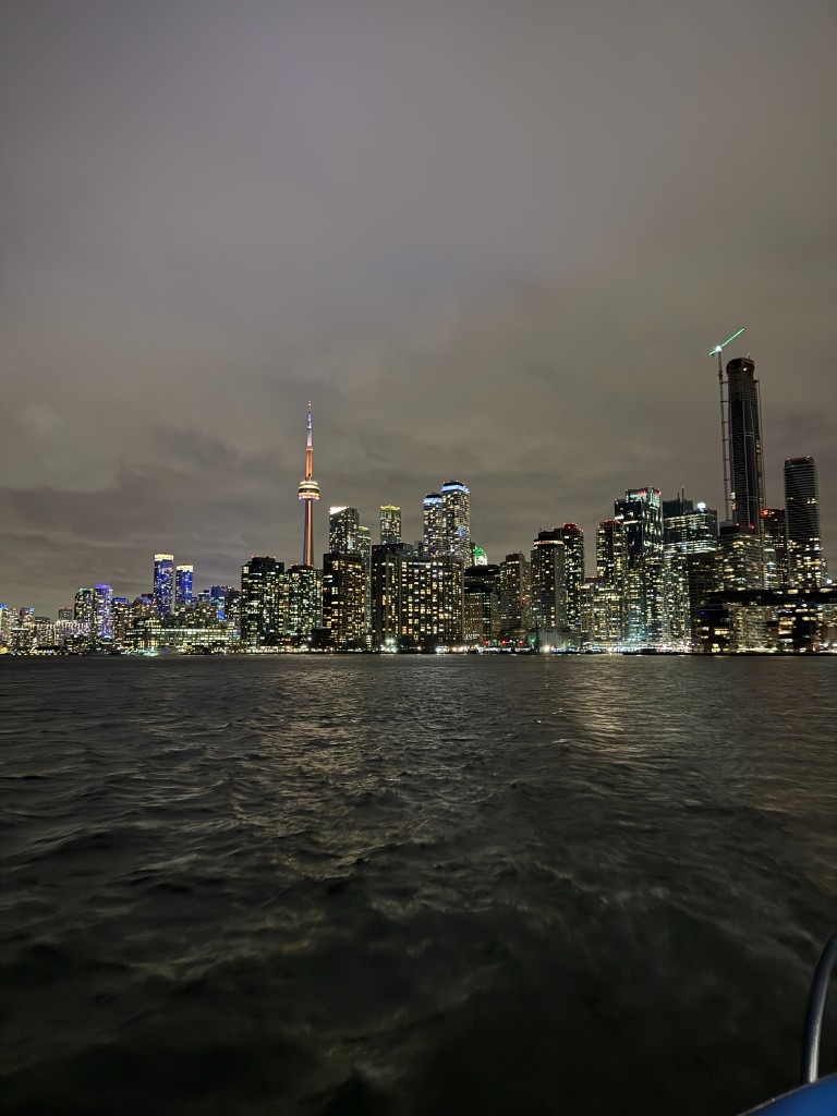 Toronto skyline glowing at night across the water
